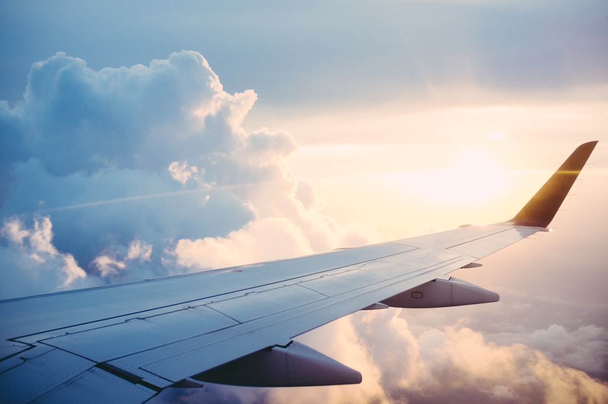 Airplane wing over clouds
